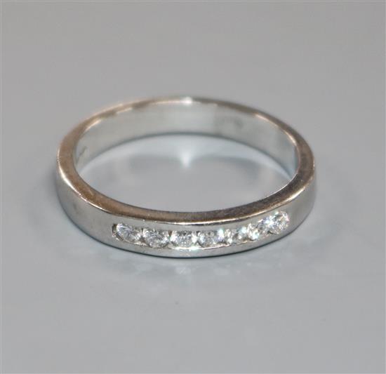 A modern 18ct white gold and seven stone diamond half hoop ring, size O.